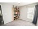 Bedroom with window and bookshelf at 17113 Sunshine Mimosa St, Wimauma, FL 33598