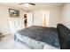 Spacious bedroom with plush carpet, neutral colors, and easy access to the bathroom at 17113 Sunshine Mimosa St, Wimauma, FL 33598