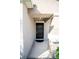 Inviting front entrance featuring a modern black door with a covered porch area at 17113 Sunshine Mimosa St, Wimauma, FL 33598