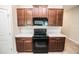 Kitchen with stainless steel oven, microwave, and wooden cabinets at 17113 Sunshine Mimosa St, Wimauma, FL 33598