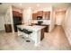 Stylish kitchen with dark cabinets, island seating, and stainless steel appliances at 17113 Sunshine Mimosa St, Wimauma, FL 33598