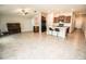 Expansive living area featuring tiled floors, an open layout, and kitchen island with bar stool seating at 17113 Sunshine Mimosa St, Wimauma, FL 33598