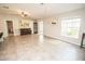Open-concept living room featuring tile floors, natural light, and neutral color palette at 17113 Sunshine Mimosa St, Wimauma, FL 33598