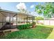 Exterior view of the screened patio provides shade and comfort in the landscaped backyard at 17113 Sunshine Mimosa St, Wimauma, FL 33598