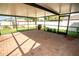 Large screened-in patio with a brick floor and a clear view of the backyard and landscaping at 17113 Sunshine Mimosa St, Wimauma, FL 33598