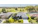 Aerial view of the home, landscaped yard, and the surrounding neighborhood with beautiful country views at 10216 Moshie Ln, San Antonio, FL 33576