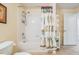 Cozy bathroom featuring a shower-tub combo with a decorative curtain and tiled floor at 10216 Moshie Ln, San Antonio, FL 33576