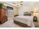 Comfortable bedroom with soft carpet, a ceiling fan, and a large wardrobe at 10216 Moshie Ln, San Antonio, FL 33576