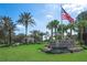 Tampa Bay Golf & Country Club entrance features lush landscaping, stately signage, and an American flag waving in the breeze at 10216 Moshie Ln, San Antonio, FL 33576
