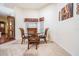 Cozy dining area featuring tile flooring, a glass-top table, and natural light through window with blinds at 10216 Moshie Ln, San Antonio, FL 33576