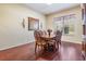 Formal dining room with wooden floors, carved-back chairs, and classic decor at 10216 Moshie Ln, San Antonio, FL 33576