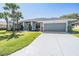 Charming single-Gathering home featuring a well-manicured lawn, a two-car garage, and mature trees at 10216 Moshie Ln, San Antonio, FL 33576