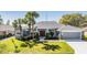Charming single-story home with a well-manicured lawn and mature landscaping at 10216 Moshie Ln, San Antonio, FL 33576