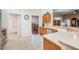 Well-lit kitchen featuring tile floors, wooden cabinets, and stainless steel appliances at 10216 Moshie Ln, San Antonio, FL 33576