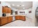 Spacious kitchen with tile flooring, stainless appliances, and an open layout into other living areas at 10216 Moshie Ln, San Antonio, FL 33576