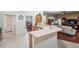 Open concept kitchen featuring a breakfast bar and a view into both the dining and living rooms at 10216 Moshie Ln, San Antonio, FL 33576