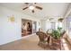 Relaxing sunroom with ceiling fans, wicker furniture, and sliding glass doors to the living room at 10216 Moshie Ln, San Antonio, FL 33576