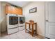 Functional laundry room with side-by-side washer and dryer, storage cabinets, and tiled floor at 10216 Moshie Ln, San Antonio, FL 33576