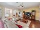 Spacious living room boasting hardwood floors, neutral decor, and access to other areas of the home at 10216 Moshie Ln, San Antonio, FL 33576
