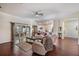 Spacious living room featuring hardwood floors, modern ceiling fan and sliding glass doors at 10216 Moshie Ln, San Antonio, FL 33576