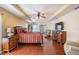 Spacious main bedroom with wood floors, tray ceilings, and a private entrance to the lanai at 10216 Moshie Ln, San Antonio, FL 33576