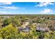 Property features a pool and mature trees; this aerial shows the neighborhood's peaceful, residential setting at 106 Indian Rocks S Rd, Belleair Bluffs, FL 33770