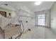 Laundry room with tiled floor, sink, wire shelving, and a bright window at 106 Indian Rocks S Rd, Belleair Bluffs, FL 33770