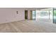 Large living room with carpet, a doorway, and views of an outdoor pool at 106 Indian Rocks S Rd, Belleair Bluffs, FL 33770