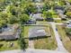 An aerial view featuring the home, its large fenced yard, and the surrounding neighborhood at 1110 S Pine Lake Dr, Tampa, FL 33612