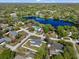 Aerial view of a neighborhood with a large pond, showcasing the home's location at 1110 S Pine Lake Dr, Tampa, FL 33612