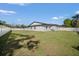 Expansive backyard featuring lush green grass and a pristine white fence for privacy at 1110 S Pine Lake Dr, Tampa, FL 33612