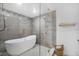 Luxurious bathroom with glass shower enclosure and modern freestanding soaking tub at 1110 S Pine Lake Dr, Tampa, FL 33612