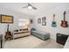 Eclectic bedroom with guitars, daybed, and vintage-inspired decor at 1110 S Pine Lake Dr, Tampa, FL 33612