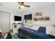 Comfortable bedroom with ceiling fan, shelves filled with books and a window at 1110 S Pine Lake Dr, Tampa, FL 33612