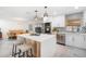 Modern kitchen boasting a center island with seating, stainless steel appliances, and an open layout to the dining area at 1110 S Pine Lake Dr, Tampa, FL 33612