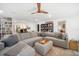 Open-concept living room with a large sectional sofa, bookshelves, and hardwood ceiling fan at 1110 S Pine Lake Dr, Tampa, FL 33612