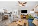 Bright living room showcasing an open layout, modern decor, ceiling fan, and seamless access to the kitchen at 1110 S Pine Lake Dr, Tampa, FL 33612
