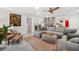 Spacious living room featuring a large gray sectional sofa, lots of seating and natural light at 1110 S Pine Lake Dr, Tampa, FL 33612