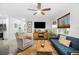 Comfortable living room featuring a ceiling fan, stylish decor, ample natural light, and modern furnishings at 1110 S Pine Lake Dr, Tampa, FL 33612