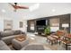 Cozy living room with a modern fireplace, a gray sofa and a ceiling fan at 1110 S Pine Lake Dr, Tampa, FL 33612