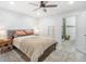 Bright main bedroom with a ceiling fan, ensuite bathroom, and stylish rug at 1110 S Pine Lake Dr, Tampa, FL 33612