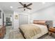 Inviting main bedroom featuring a ceiling fan, neutral tones, and hardwood nightstands at 1110 S Pine Lake Dr, Tampa, FL 33612