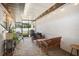 Covered patio with stone pavers, string lights, and comfortable seating arrangement at 1110 S Pine Lake Dr, Tampa, FL 33612