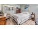 Inviting bedroom with wood floors, a decorative chair, a dresser, and soft natural light at 1159 Montrose Pl, Dunedin, FL 34698