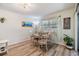 Cozy dining area with a round table, four chairs, and soft natural light from a nearby window at 1159 Montrose Pl, Dunedin, FL 34698