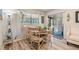 Charming dining space with a round table, decorative accents, and easy access to the outdoor lanai at 1159 Montrose Pl, Dunedin, FL 34698