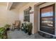 Inviting front porch featuring a rocking chair and a neatly decorated entrance with potted plants at 1159 Montrose Pl, Dunedin, FL 34698