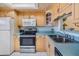 Charming kitchen with wood cabinets, updated appliances, and a window above the double sink at 1159 Montrose Pl, Dunedin, FL 34698