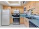 Well-lit kitchen with light wood cabinets, stainless steel appliances, and a functional layout at 1159 Montrose Pl, Dunedin, FL 34698