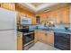 Functional kitchen featuring light wood cabinets, updated appliances, and ample counter space at 1159 Montrose Pl, Dunedin, FL 34698